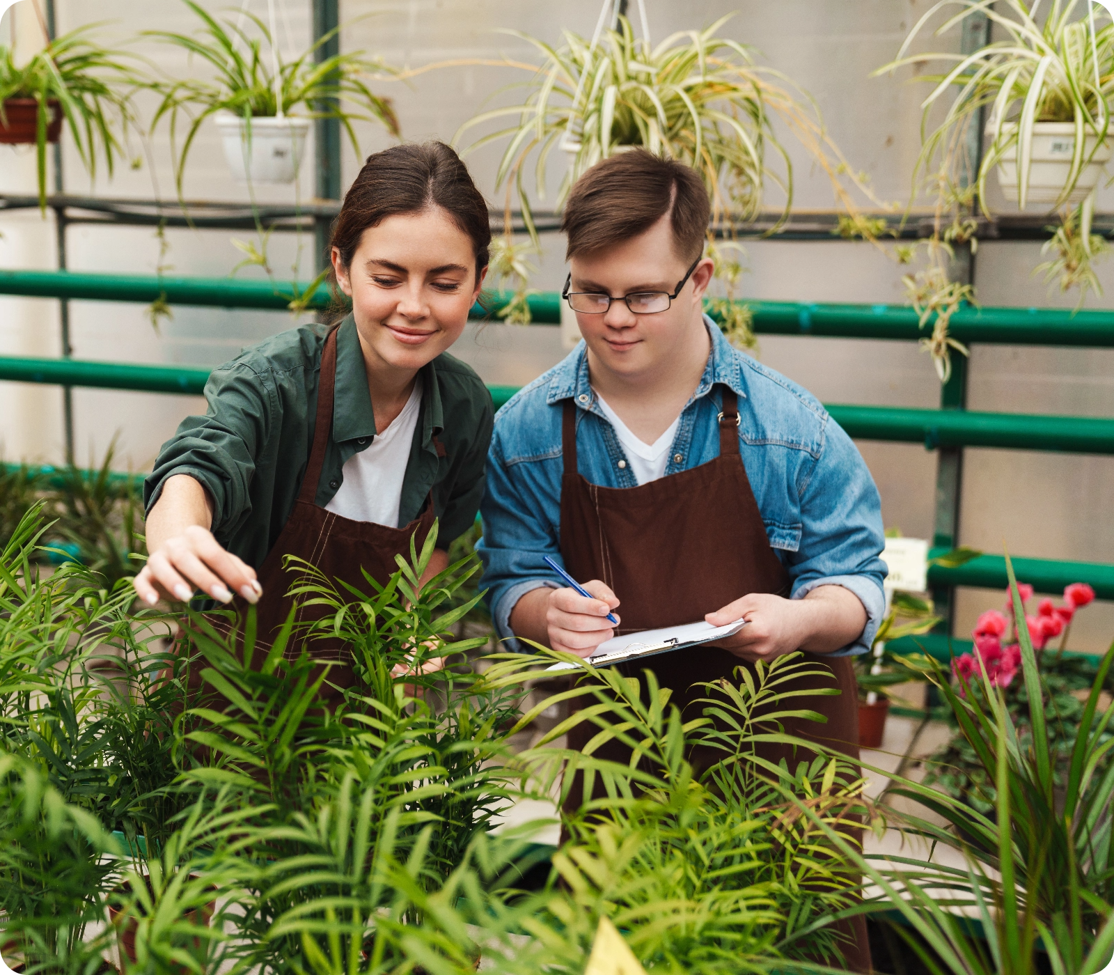 Lady and boy caring for plants